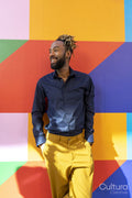 Smiling businessman standing against colorful wall