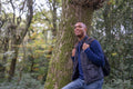 Smiling man hiking in forest
