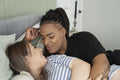 Two young women embracing in bed