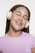 Studio portrait of smiling girl with headphones and eyes closed