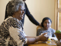 Family sitting at table and eating breakfast
