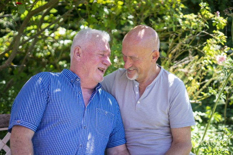 Senior male couple relaxing in garden