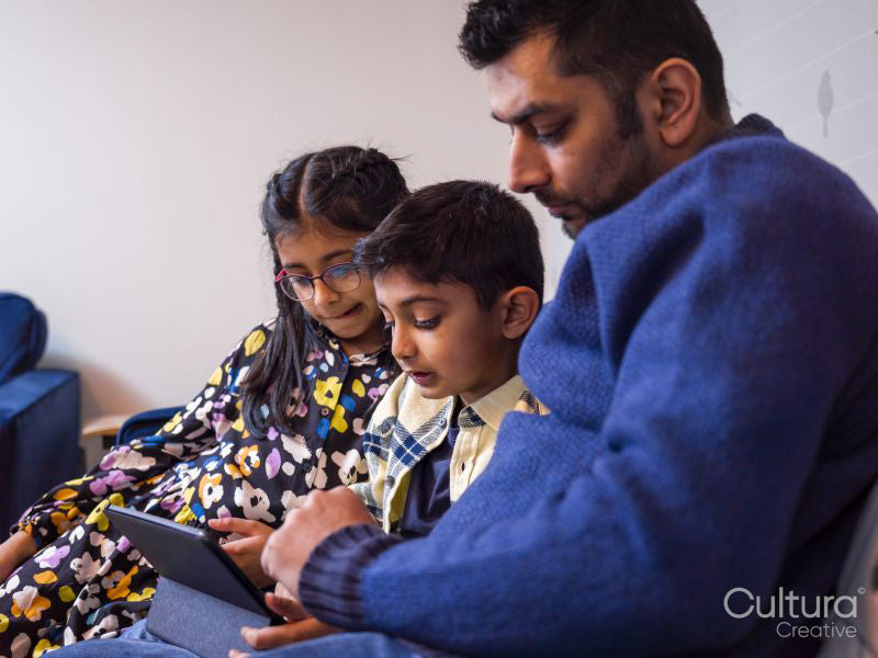 Father and children using digital tablet