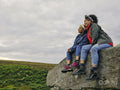Female hikers sitting on rocks and looking at landscape