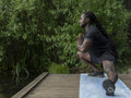 Man practicing yoga in park