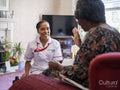 Elderly woman talking with nurse