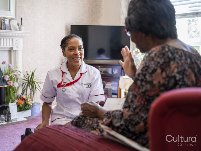 Elderly woman talking with nurse