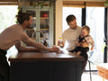 couple feeding baby daughter in kitchen