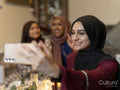 Smiling women taking selfie during Ramadan at home