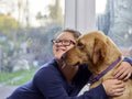 Girl with Down syndrome hugging dog