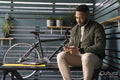 Man sitting in lounge room and using phone
