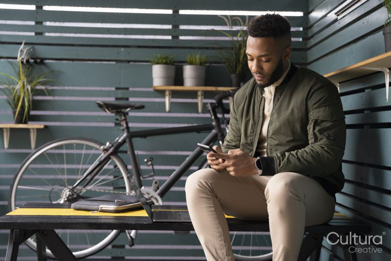Man sitting in lounge room and using phone