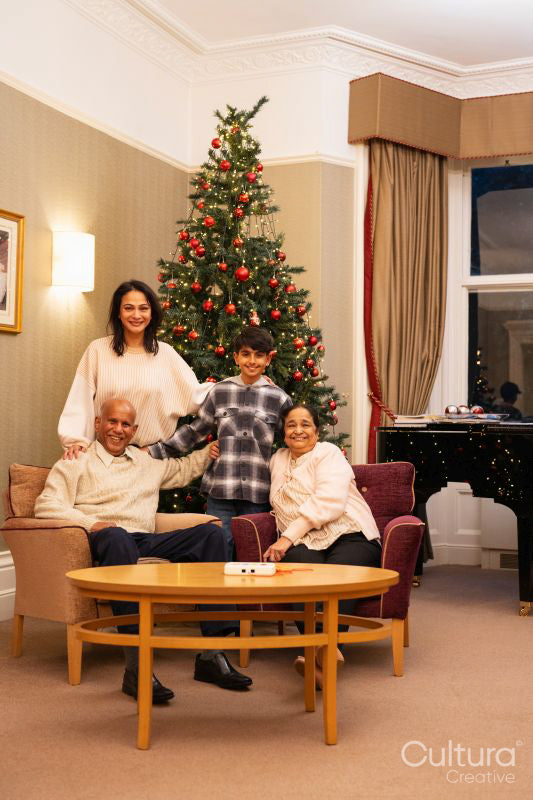 Multi generation family with boy during Christmas time in nursing home