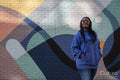 South Yorkshire, Smiling woman with braided hair against colorful wall