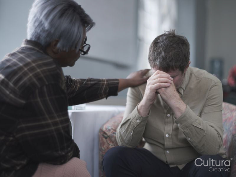 Therapist consoling patient in therapy session