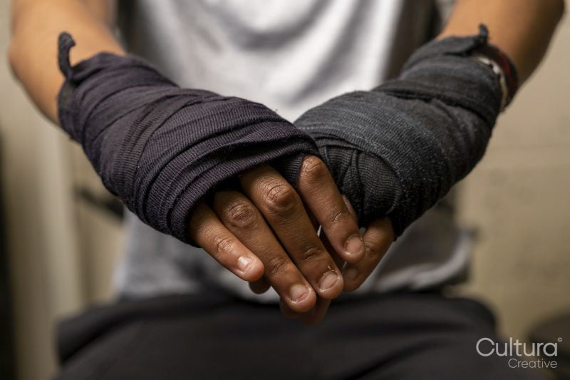 Young woman with hands wrapped before boxing match, close up