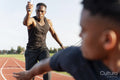 Two athletes running in relay race