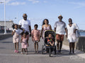 Family with children walking on promenade