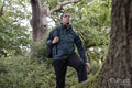 Man with backpack hiking in forest