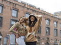 Two young women posing for portrait in urban setting