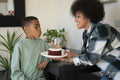 Boy blowing candles on birthday cake