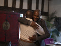 Smiling mature brothers hugging at home