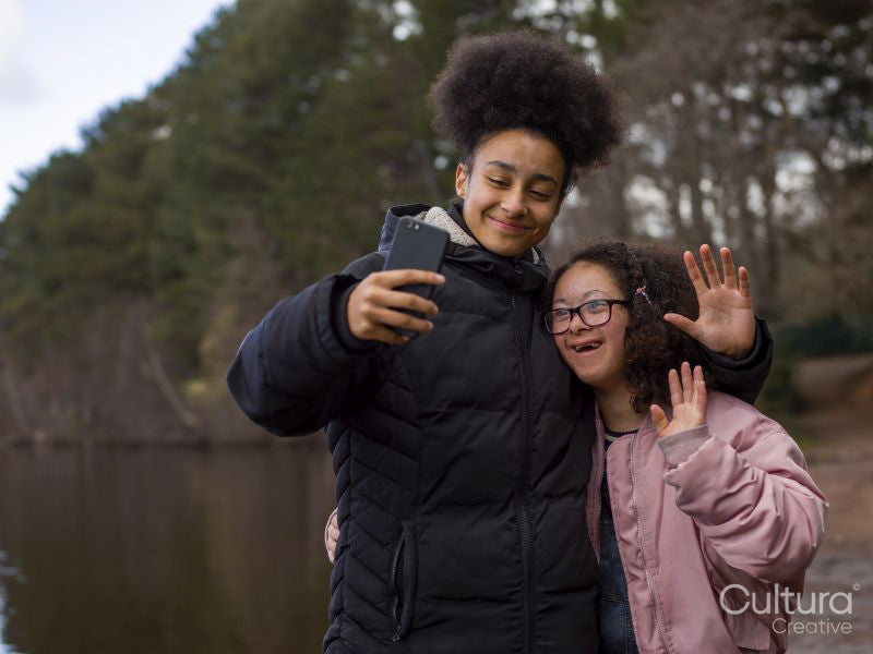 Two girls taking selfie outdoors