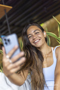 Woman sitting in hotel lounge and using mobile phone