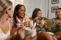 Woman sitting on sofa during girls night in