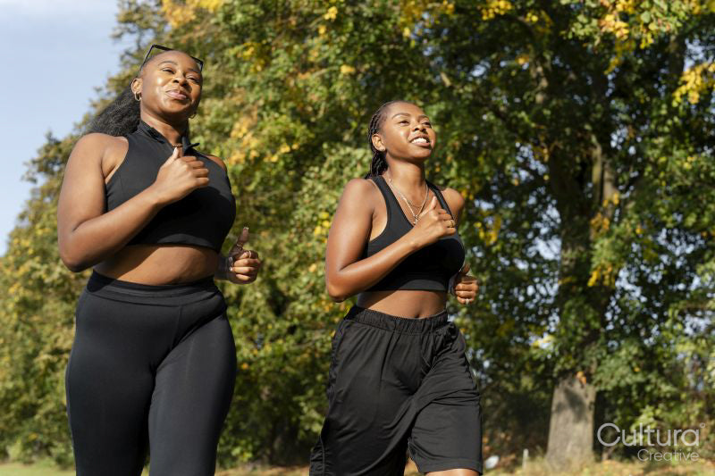 Young female friends jogging in park