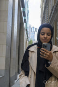 Young woman using phone in street