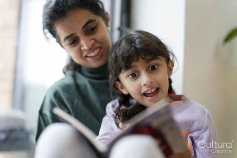 Mother and daughter reading book
