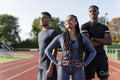 Portrait of group of athletes standing at stadium