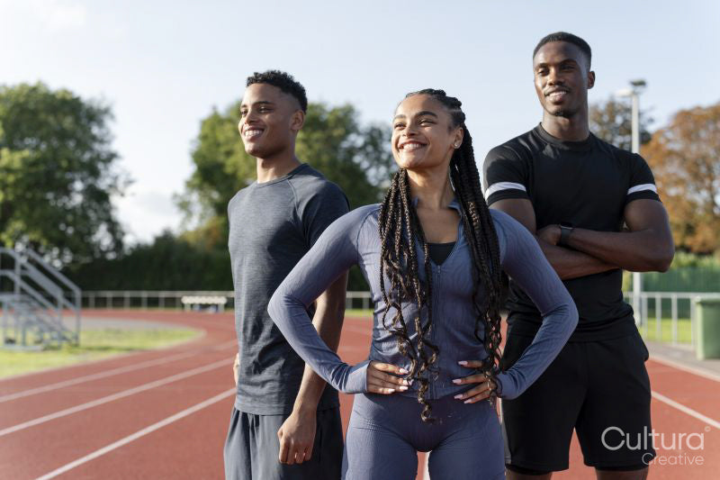 Portrait of group of athletes standing at stadium