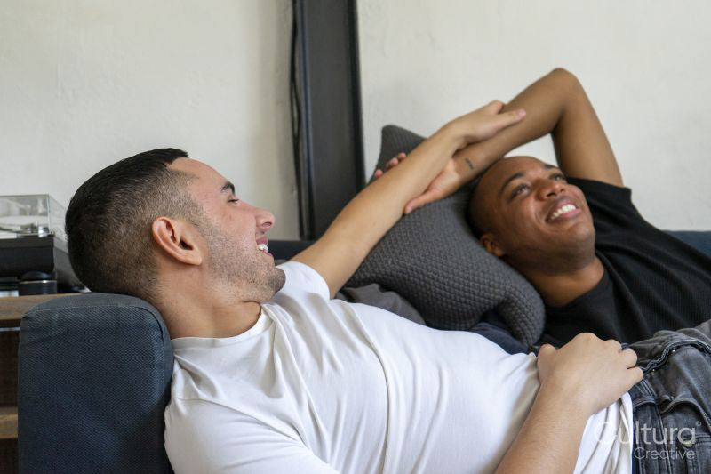 Smiling couple rela,ing on sofa