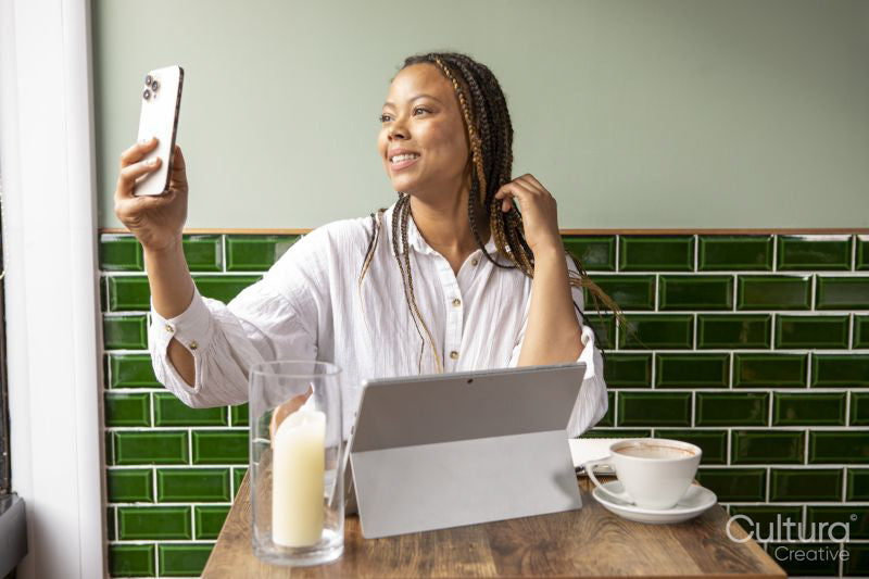 Smiling woman having video call at cafe table