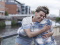 Young men hugging