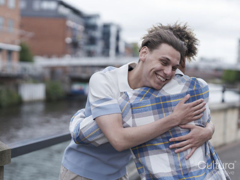 Young men hugging