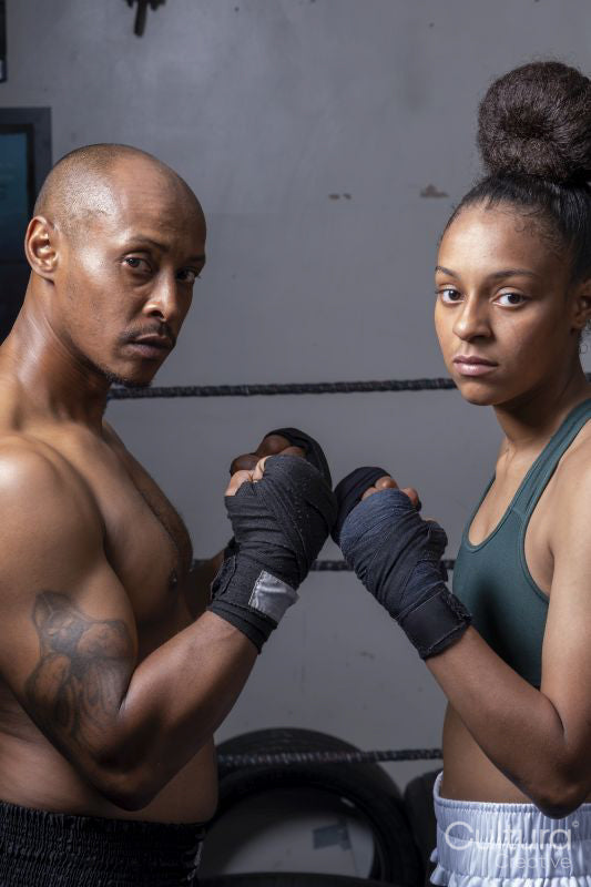 Woman and man preparing to fight in boxing ring
