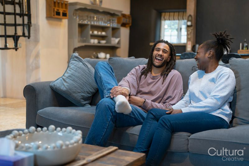 Happy couple sitting on sofa in cozy living room