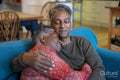 Senior couple sitting on sofa and embracing