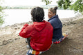 Mother and son relaxing by lake