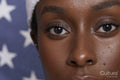 Close-up of athletic woman in front of American flag