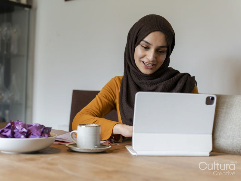 Woman using tablet at table at home