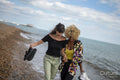 Female couple walking on beach