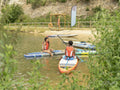 Friends relaxing on paddleboard on lake