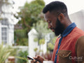 Profile of man looking at smart phone outdoors