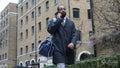 Business man walking and using phone