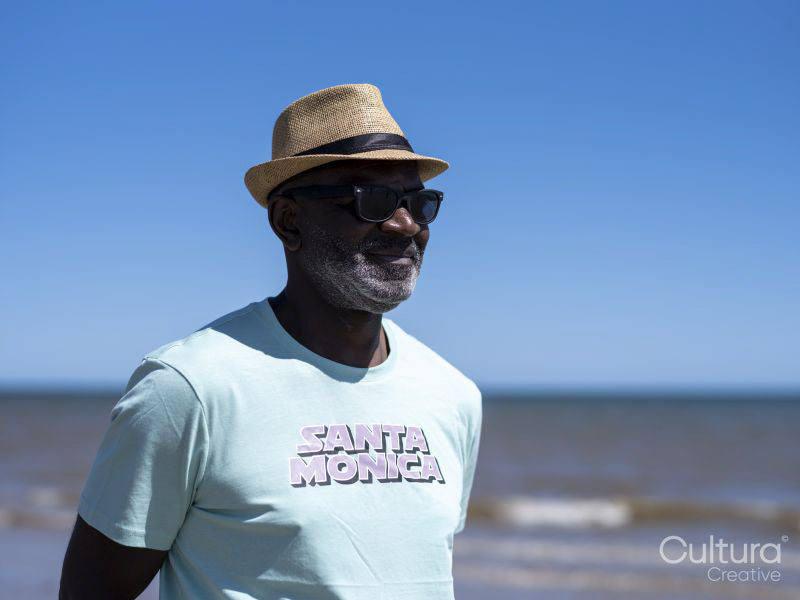 Smiling senior man on beach