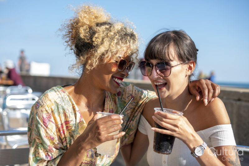 Female couple having dreams in outdoor cafe